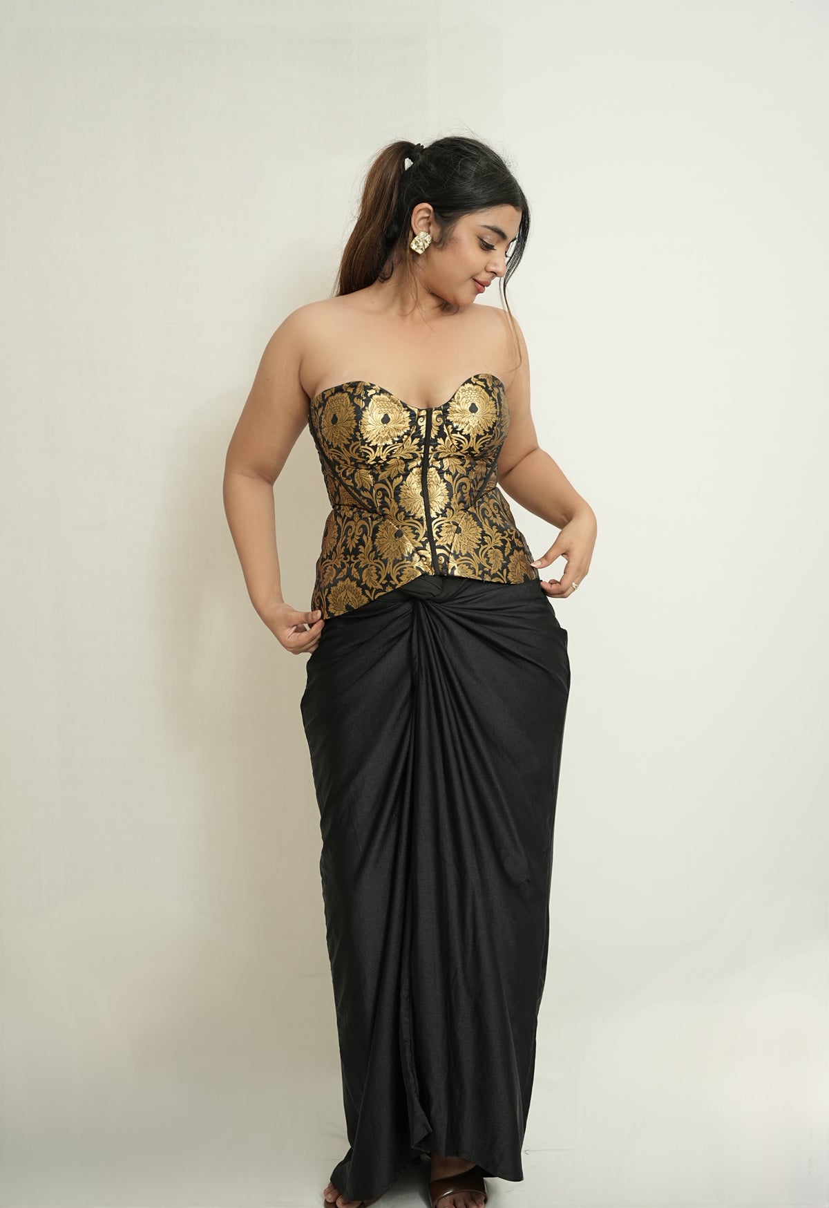 She became the moment | Gold and black brocade corset and drape skirt set.